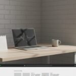 A tidy desk with a laptop displaying a clean desktop, symbolizing digital organization.